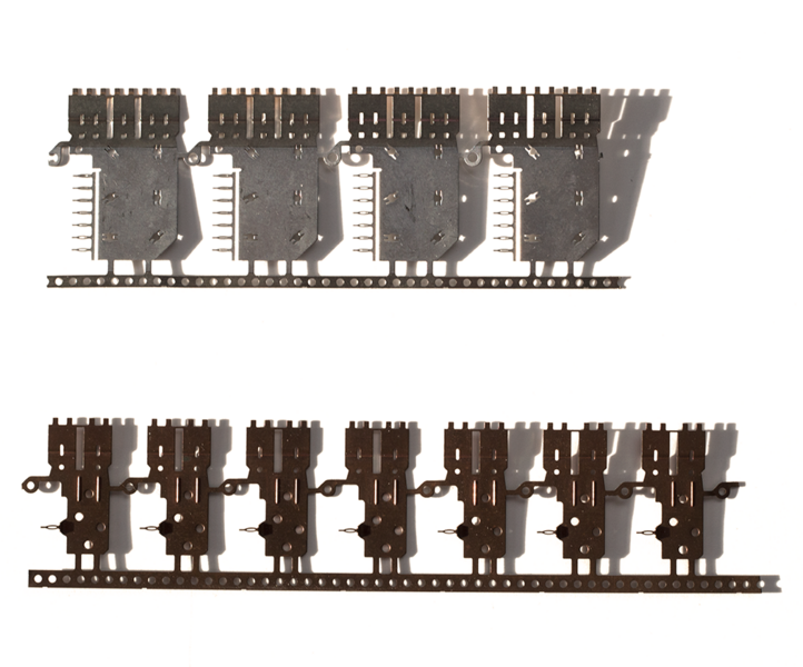 Small copper parts are show, on the top, coated with nanocrystalline nickel, free from corrosion. On the bottom, similar parts without the nickel coating are shown beginning to corrode.